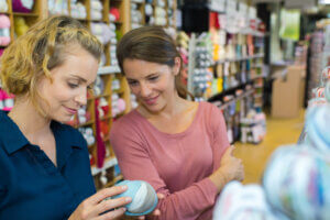 female customers buying bed cover in textile department