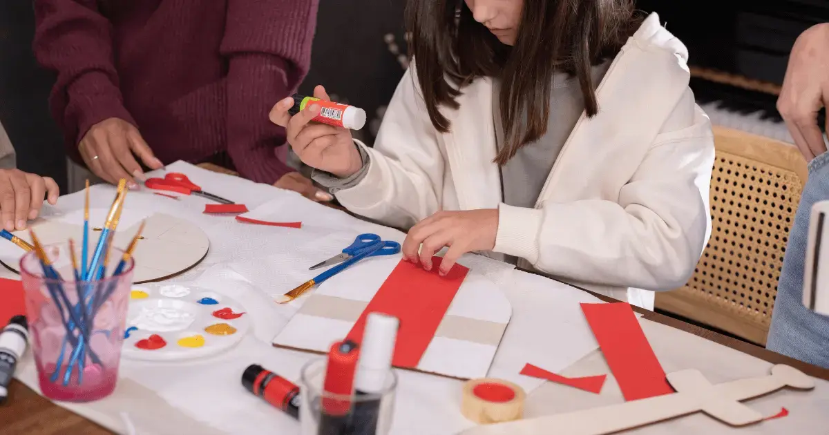 girl doing crafts on a table