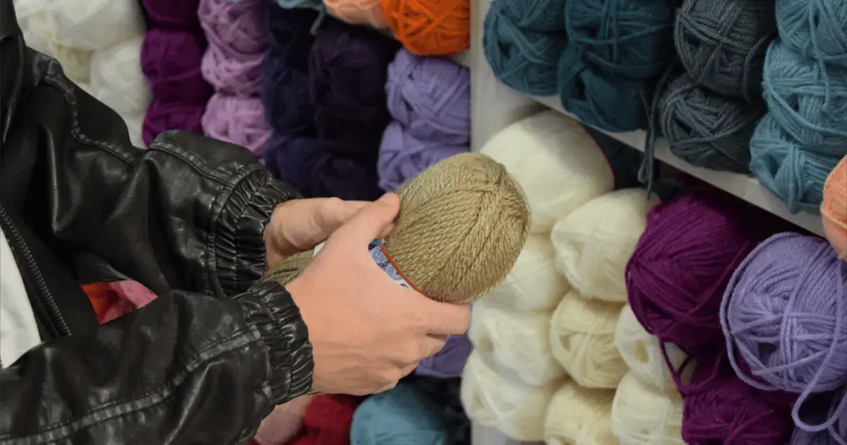 person holding yarn in a craft store