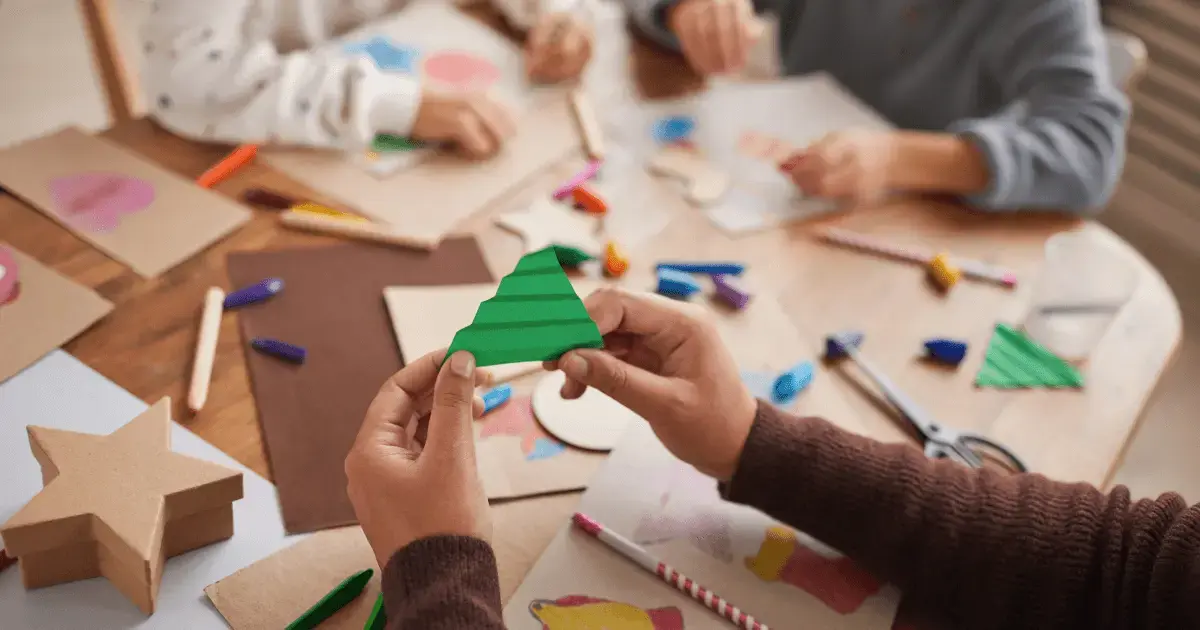 people at a table building craft kits