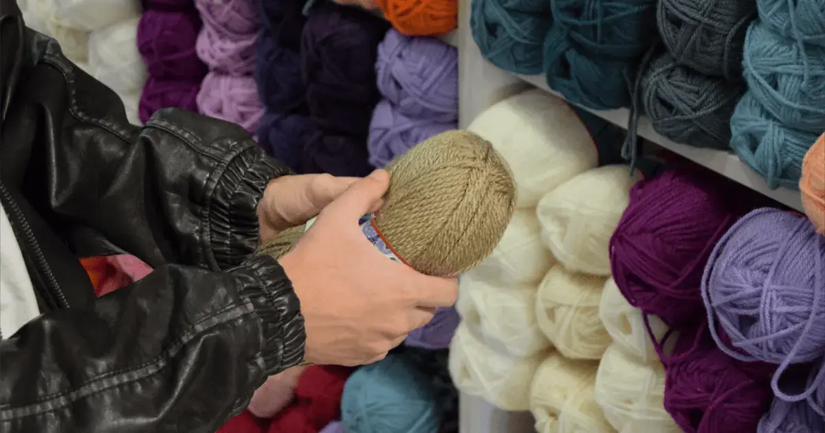 person holding yarn in a craft store
